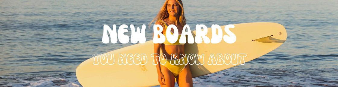 Woman standing with board with ocean behind